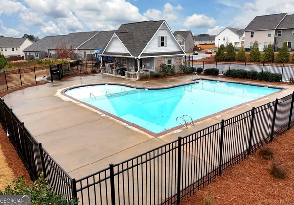 an outdoor space with swimming pool and furniture