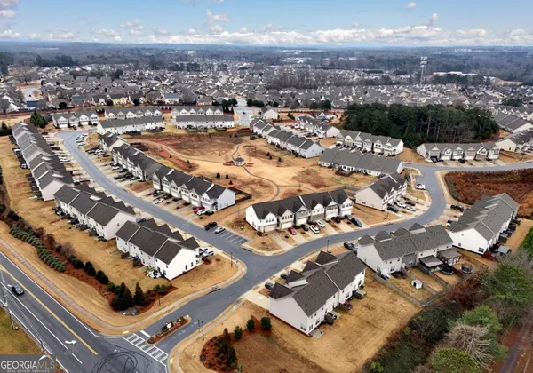 an aerial view of residential houses with city view