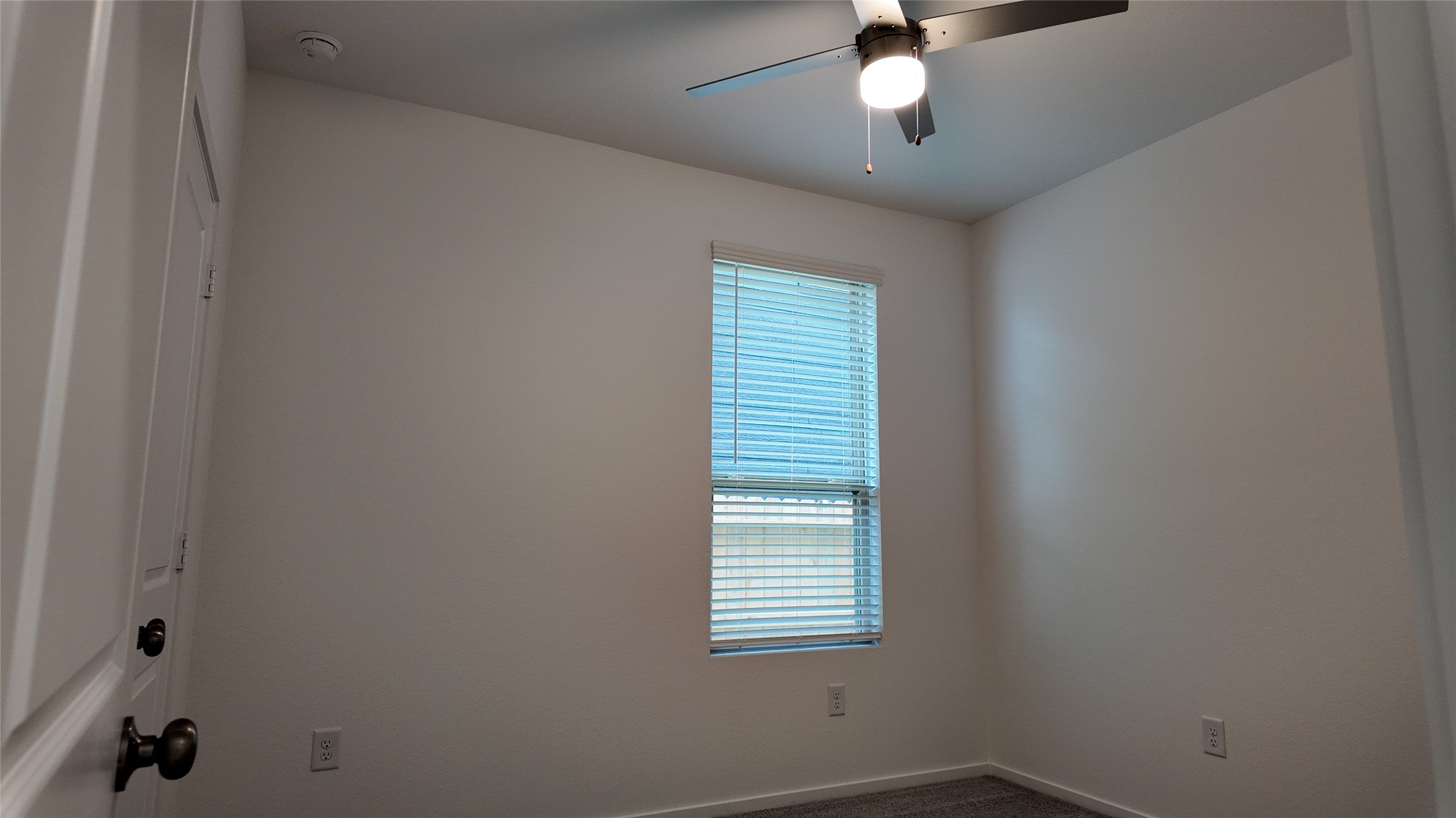 15023 Rustic Moon Road Conroe, TX 77302 - Photo 12 of 18 an empty room with a window and a ceiling fan