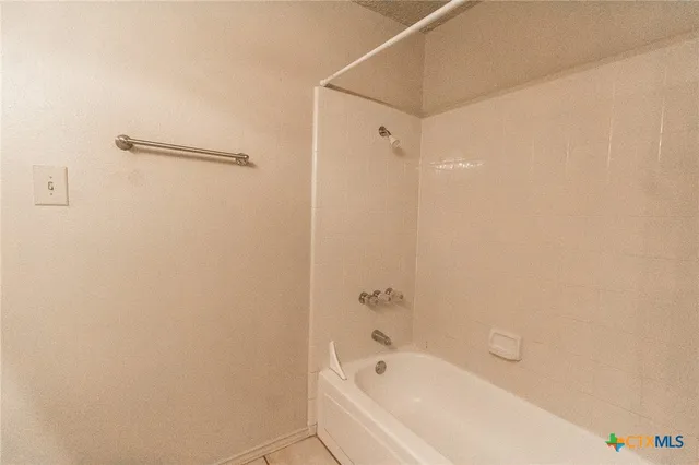 a bathroom with a bathtub and shower