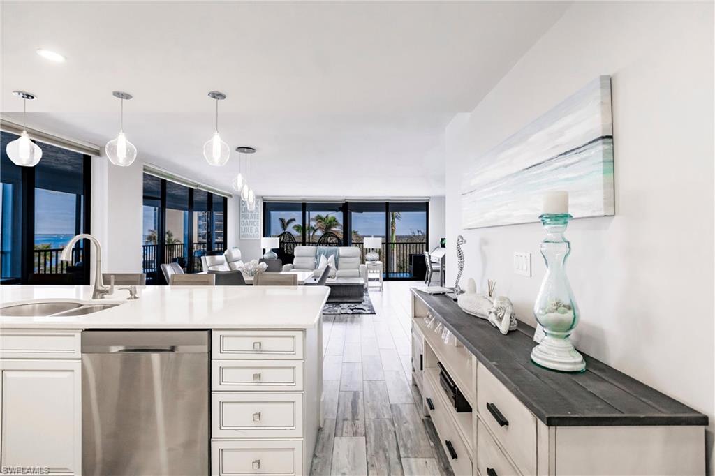 17170 Harbour Point Drive, Unit 437 Fort Myers, FL 33908 - Photo 13 of 41 Kitchen with dishwasher, expansive windows, decorative light fixtures, and sink