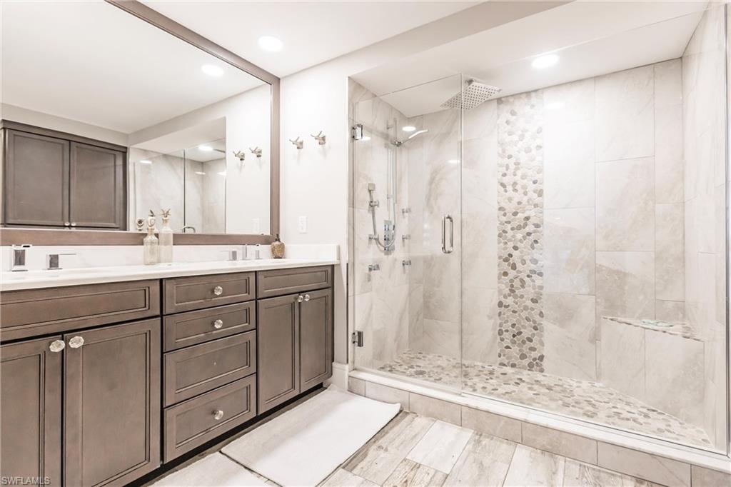 17170 Harbour Point Drive, Unit 437 Fort Myers, FL 33908 - Photo 21 of 41 Bathroom with vanity and a shower with door