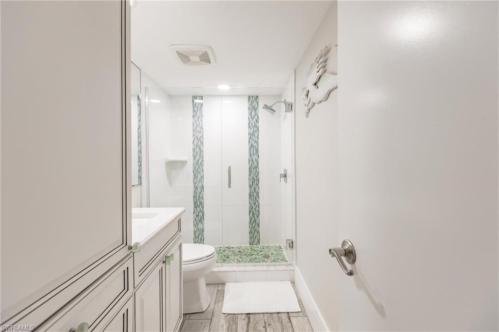 17170 Harbour Point Drive, Unit 437 Fort Myers, FL 33908 - Photo 28 of 41 Bathroom with vanity, toilet, and an enclosed shower