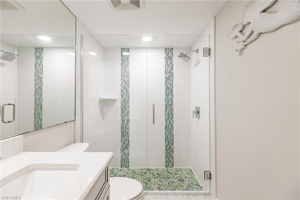 17170 Harbour Point Drive, Unit 437 Fort Myers, FL 33908 - Photo 29 of 41 Bathroom with vanity, toilet, and a shower with shower door