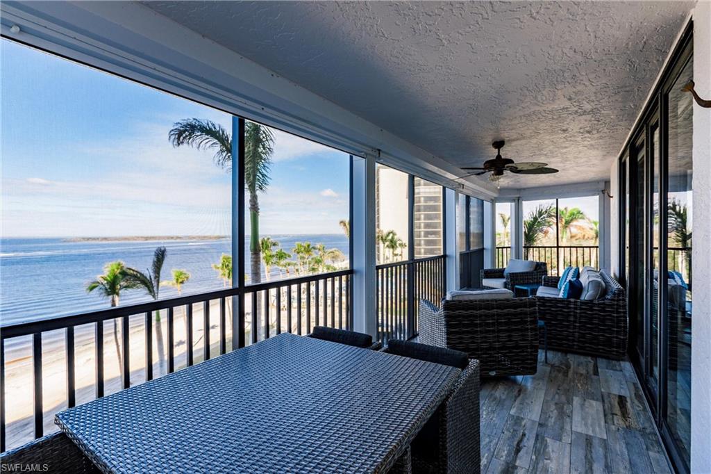 17170 Harbour Point Drive, Unit 437 Fort Myers, FL 33908 - Photo 30 of 41 Sunroom with ceiling fan and a water view
