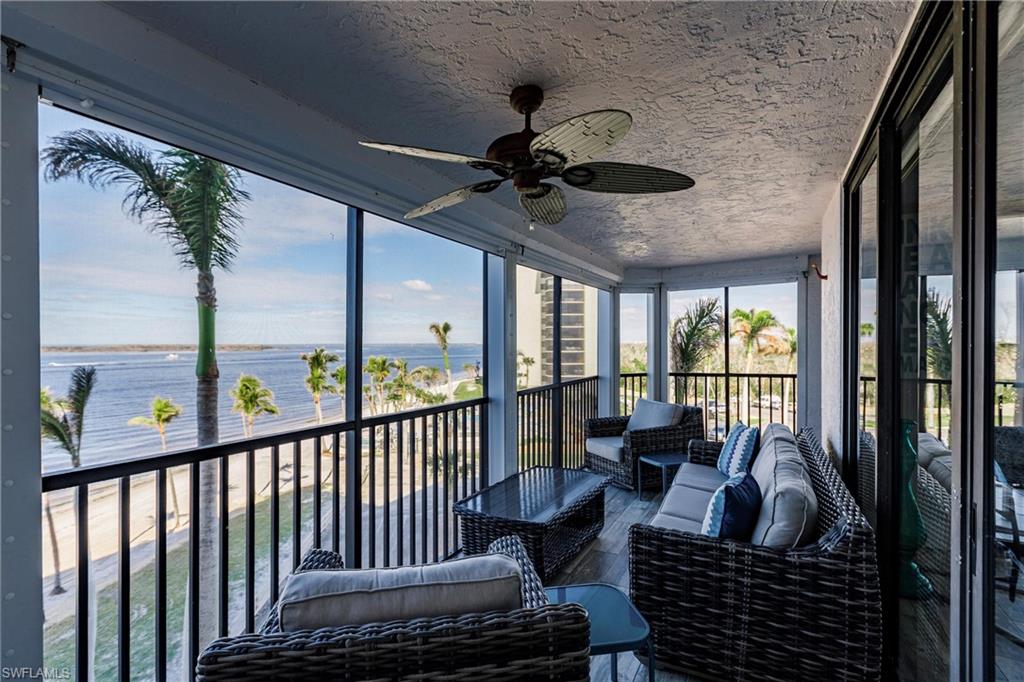 17170 Harbour Point Drive, Unit 437 Fort Myers, FL 33908 - Photo 32 of 41 Sunroom featuring ceiling fan and a water view