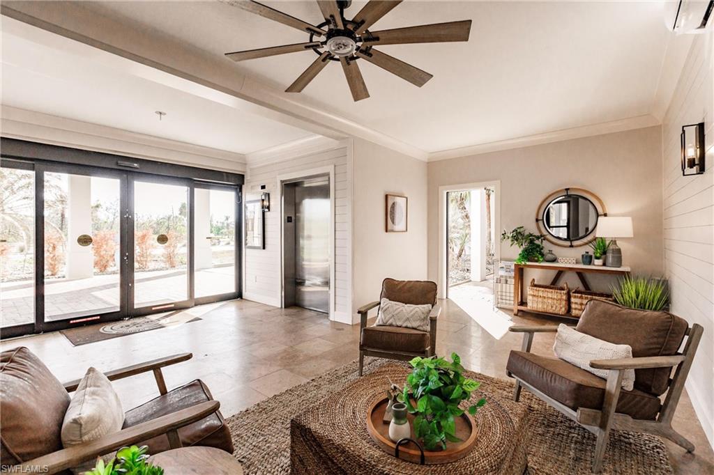 17170 Harbour Point Drive, Unit 437 Fort Myers, FL 33908 - Photo 40 of 41 Living room with french doors, crown molding, elevator, ceiling fan, and a wall mounted AC