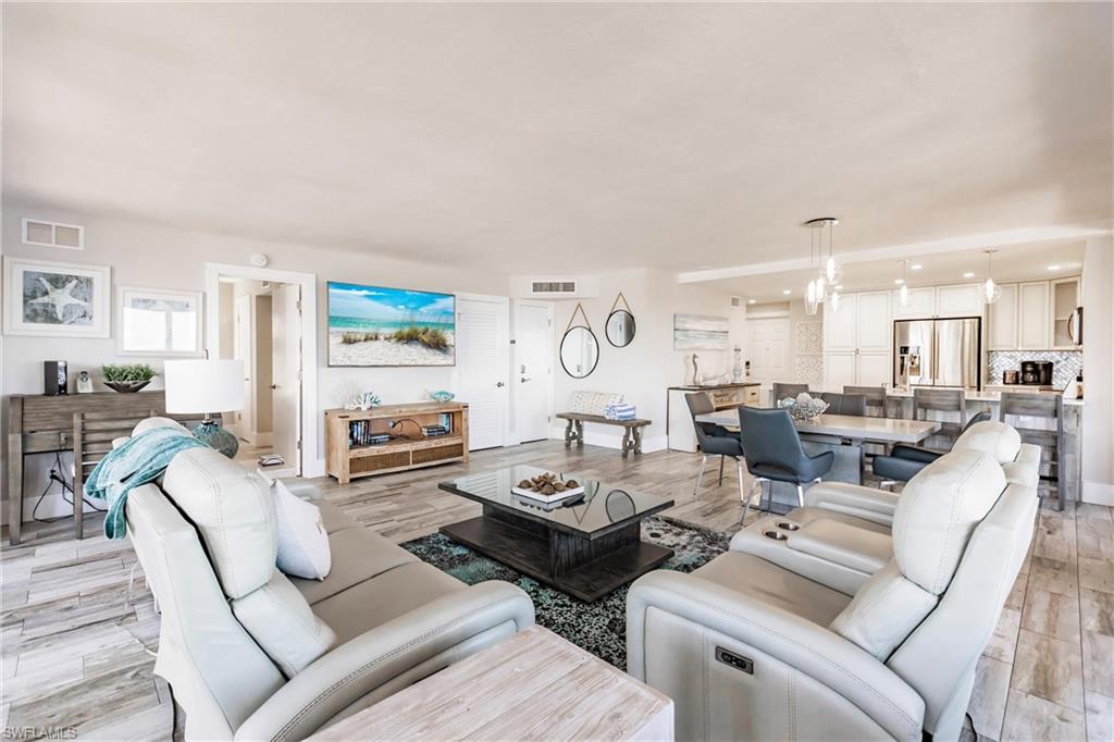 17170 Harbour Point Drive, Unit 437 Fort Myers, FL 33908 - Photo 4 of 41 Living room with a chandelier and light hardwood / wood-style floors