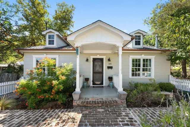 a front view of a house with garden