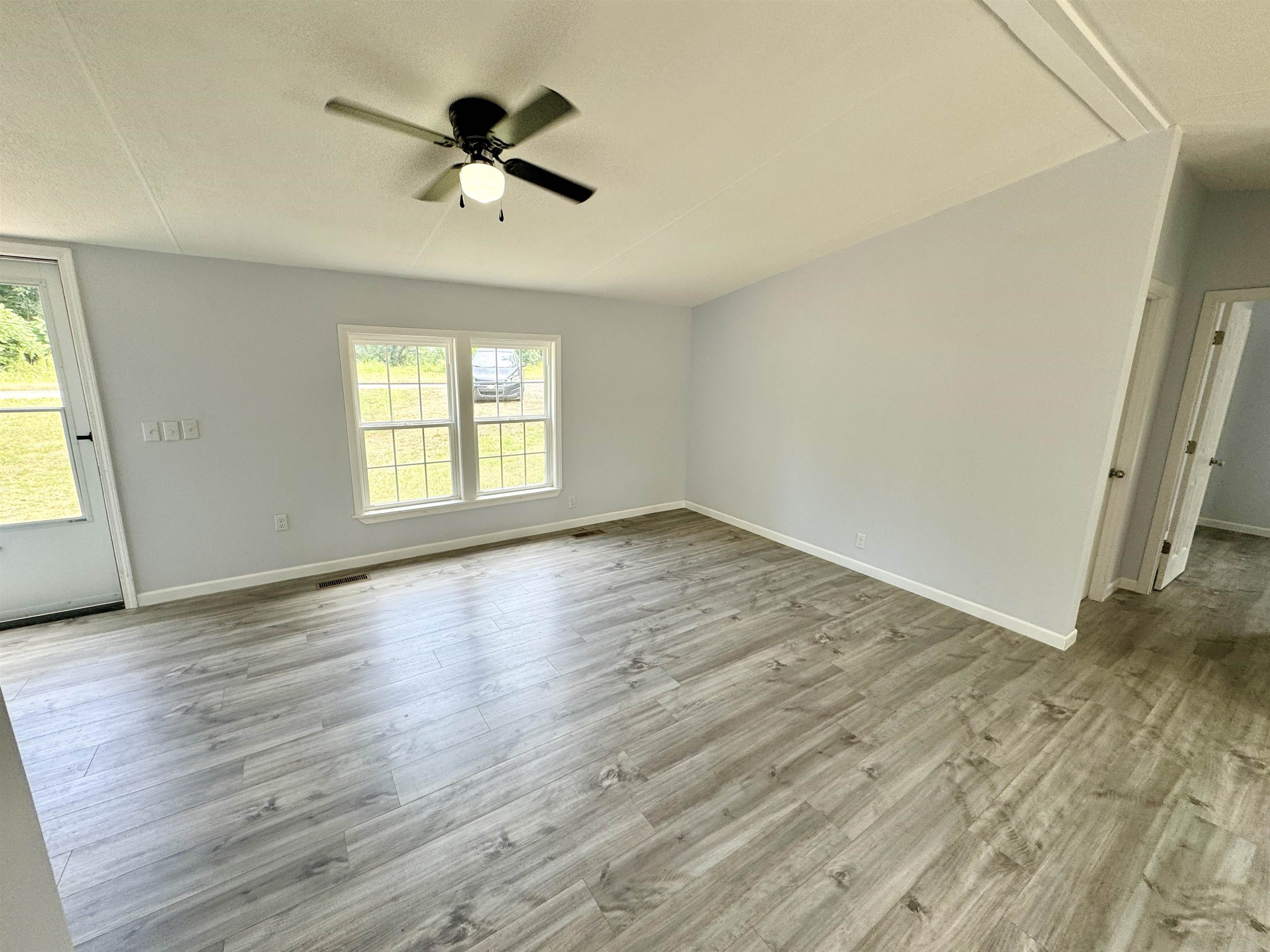 723 Patton Lane Ripley, TN 38063 - Photo 11 of 22 wooden floor in an empty room with a window