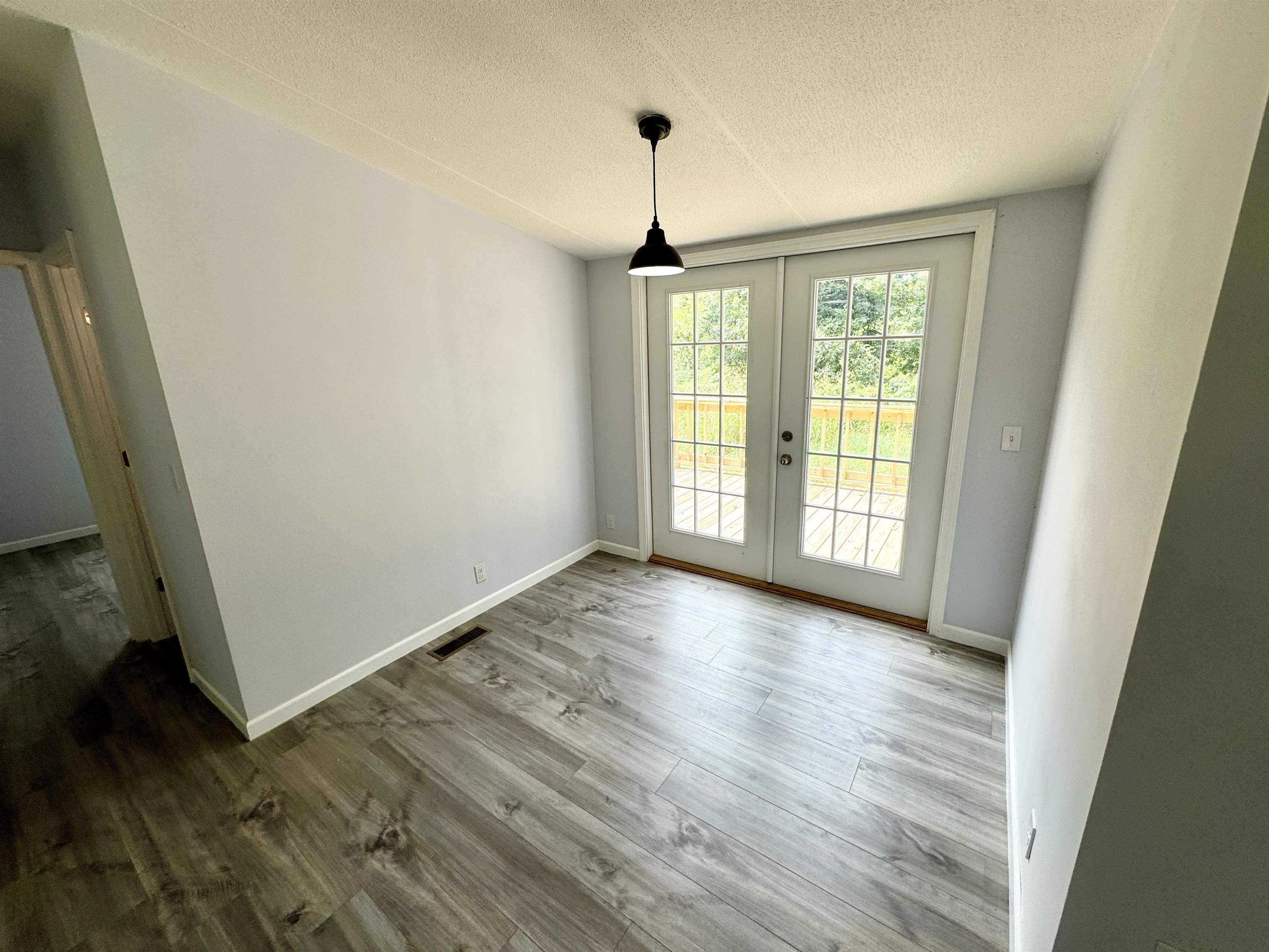 723 Patton Lane Ripley, TN 38063 - Photo 13 of 22 a view of an empty room with wooden floor and a window