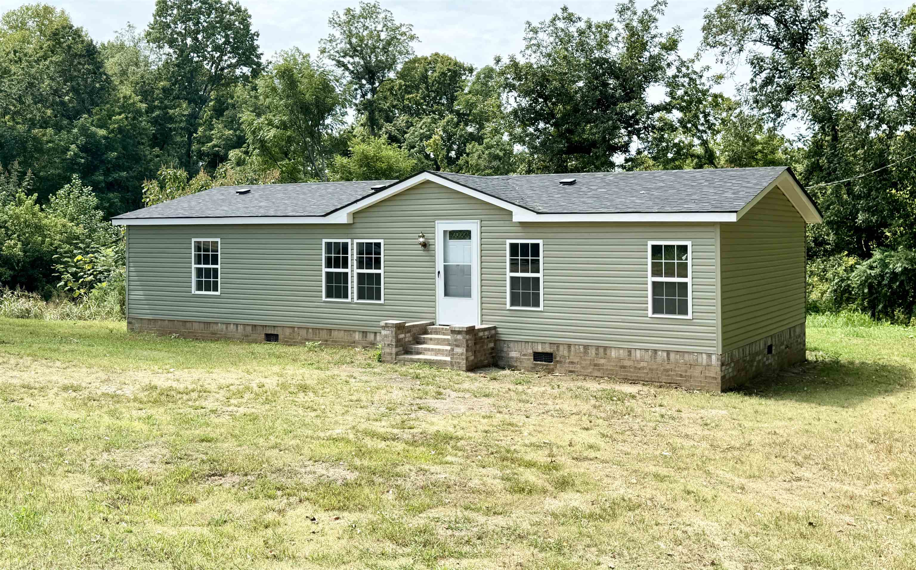 723 Patton Lane Ripley, TN 38063 - Photo 4 of 22 a house with trees in the background