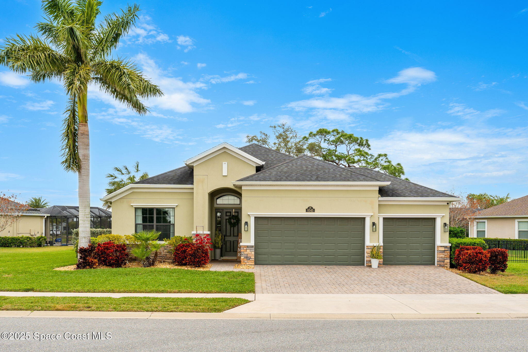 8545 Stalwart Circle Melbourne, FL 32940 - Photo 1 of 51 a view of a white house in front of a yard with potted plants