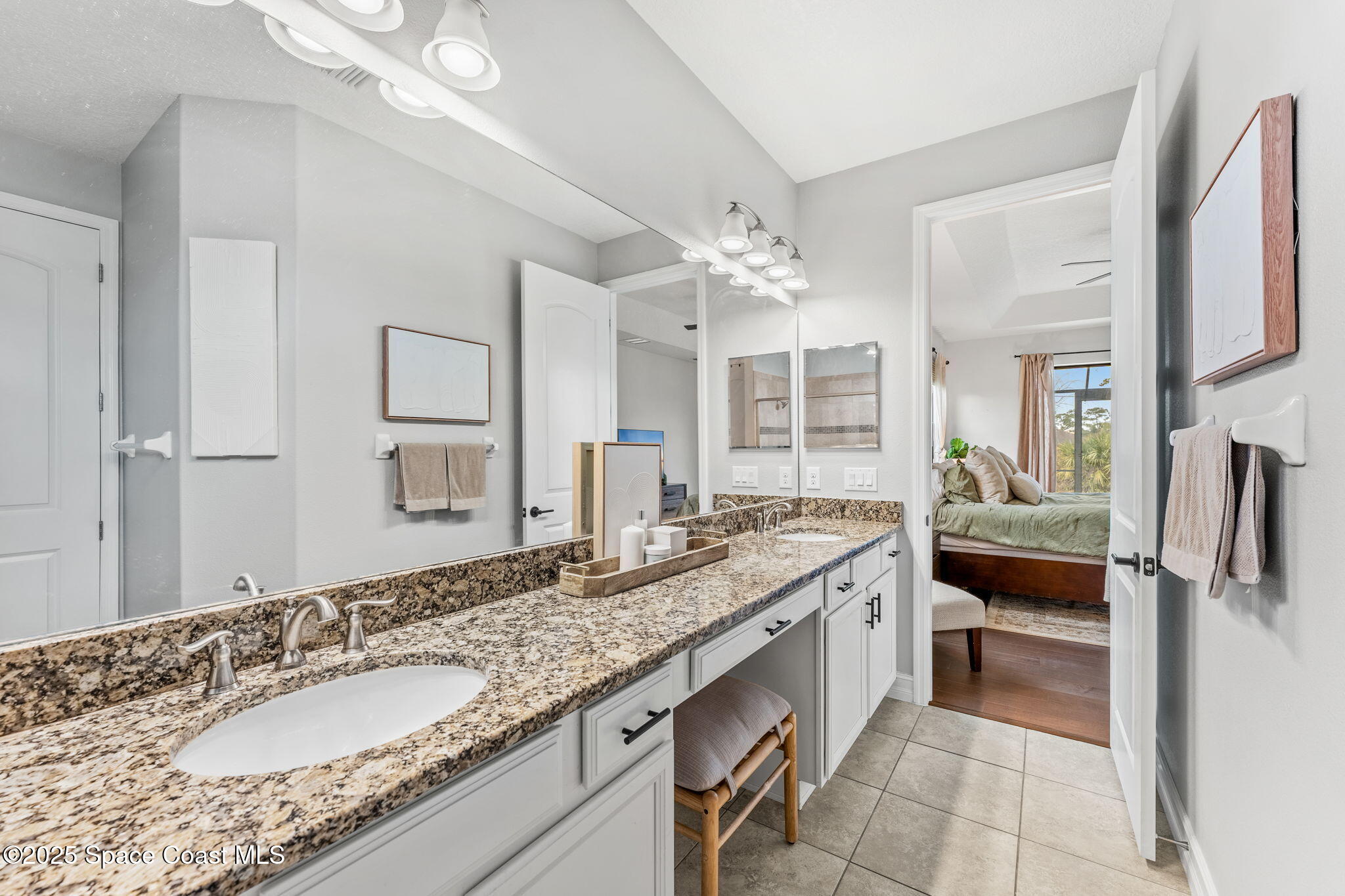 8545 Stalwart Circle Melbourne, FL 32940 - Photo 12 of 51 a spacious bathroom with a granite countertop sink and a mirror
