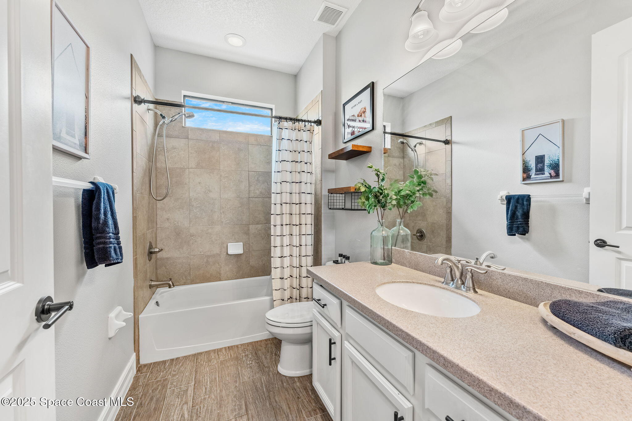 8545 Stalwart Circle Melbourne, FL 32940 - Photo 25 of 51 a bathroom with a granite countertop sink toilet and shower