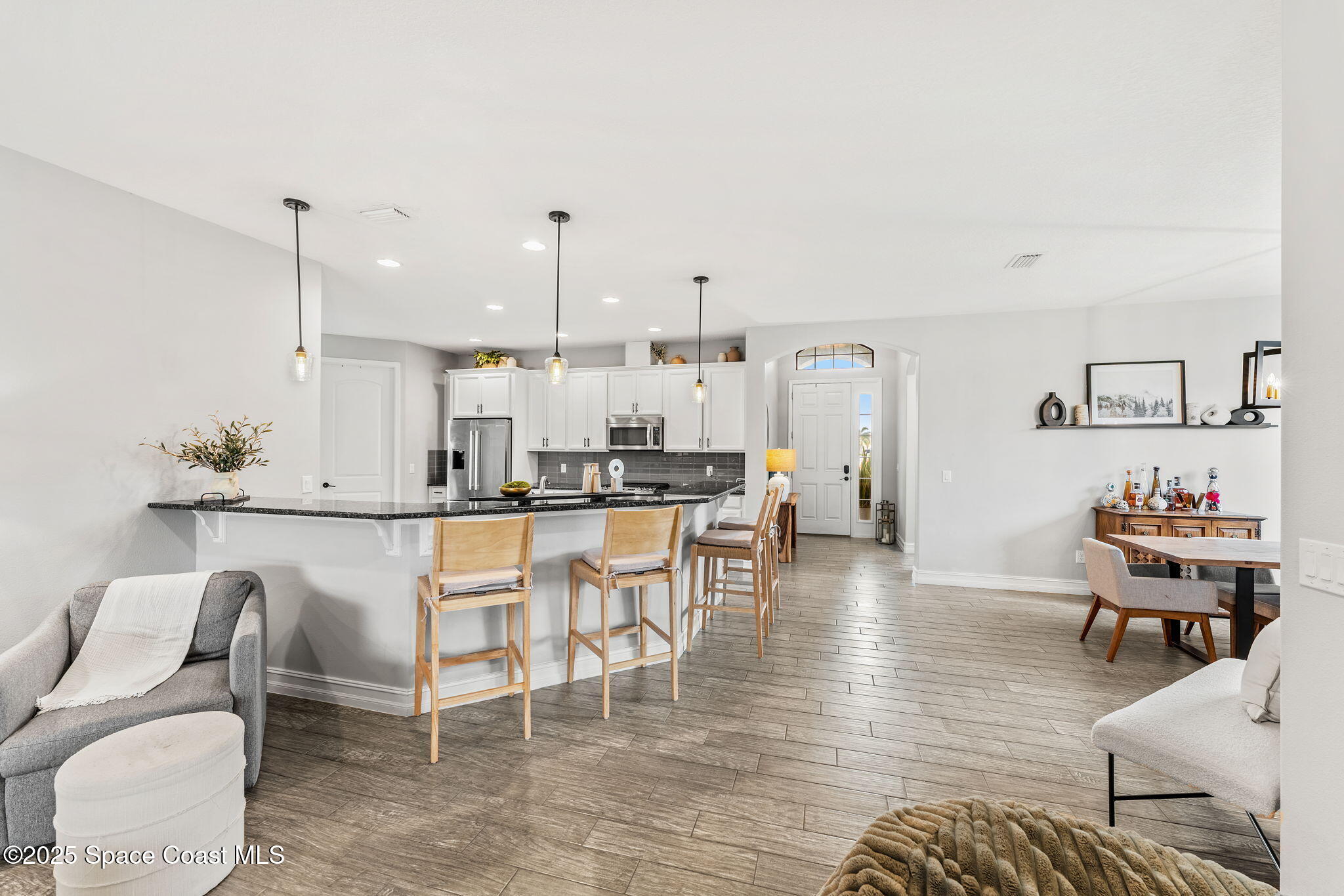 8545 Stalwart Circle Melbourne, FL 32940 - Photo 30 of 51 a living room with furniture a table and kitchen view