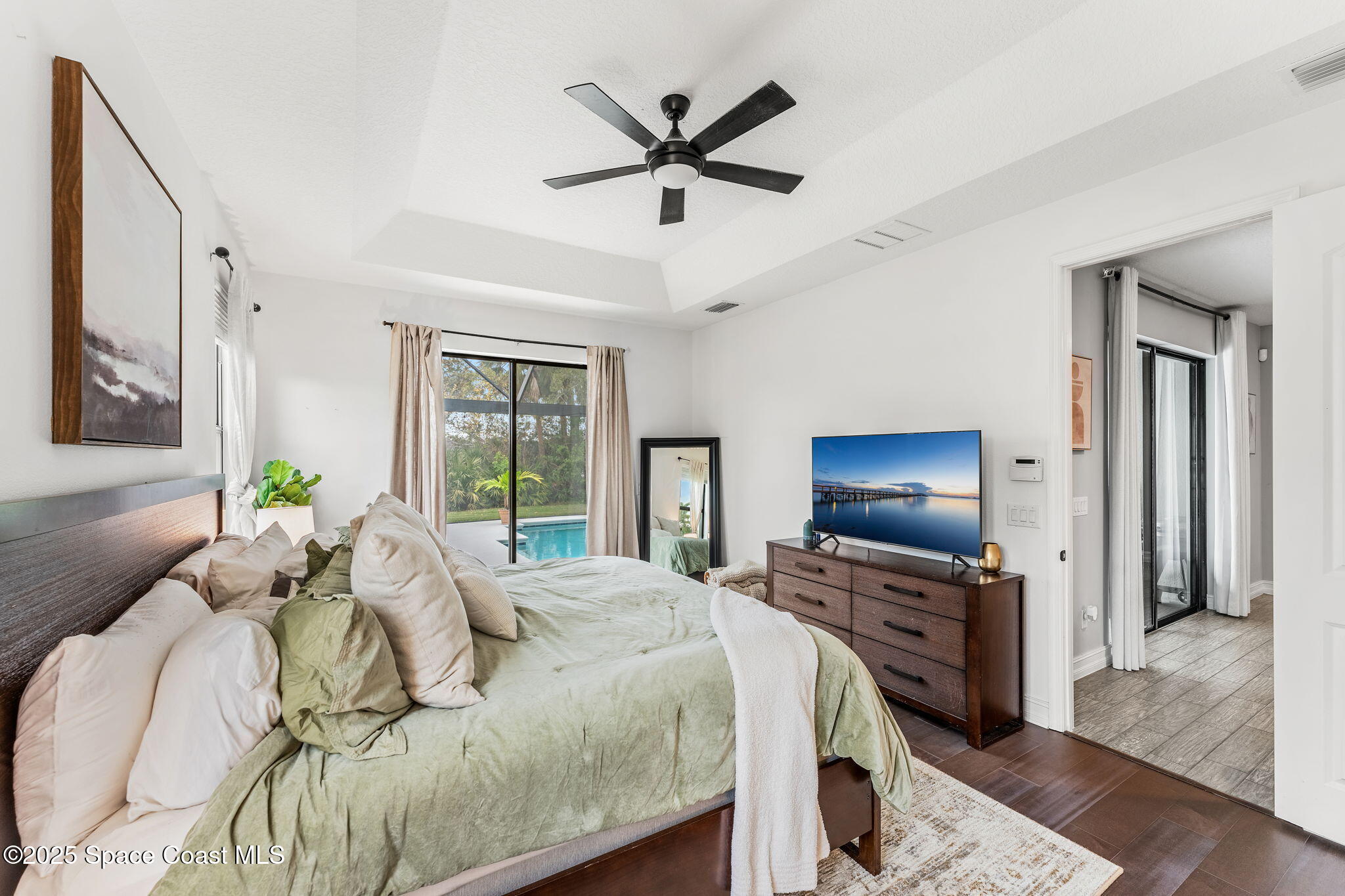 8545 Stalwart Circle Melbourne, FL 32940 - Photo 10 of 51 a bedroom with a bed and a flat screen tv