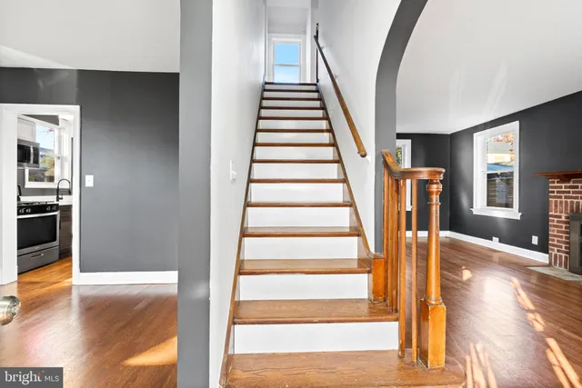 a view of entryway and hall with wooden floor