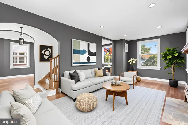 a living room with furniture and wooden floor