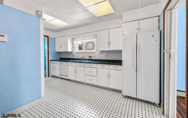 a spacious bathroom with a granite countertop sink a mirror and a shower