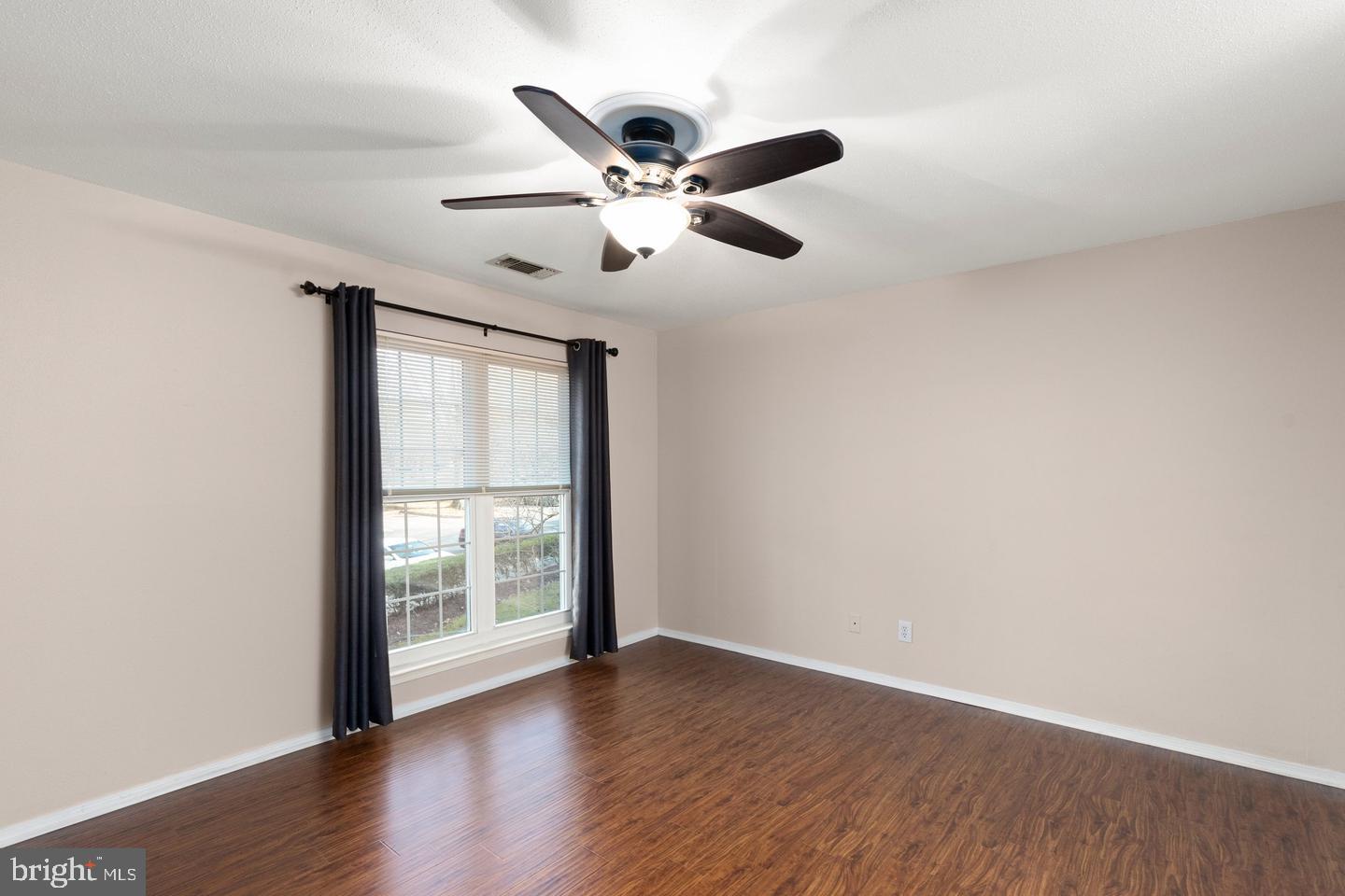 308 G Canterbury Road, Unit 308G Bel Air, MD 21014 - Photo 11 of 25 an empty room with wooden floor fan and windows