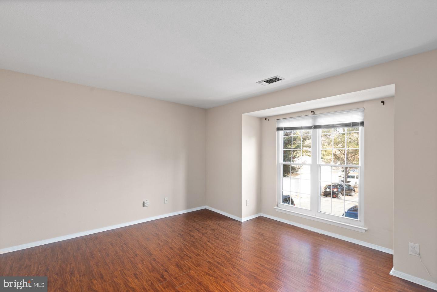 308 G Canterbury Road, Unit 308G Bel Air, MD 21014 - Photo 16 of 25 a view of an empty room with wooden floor and a window