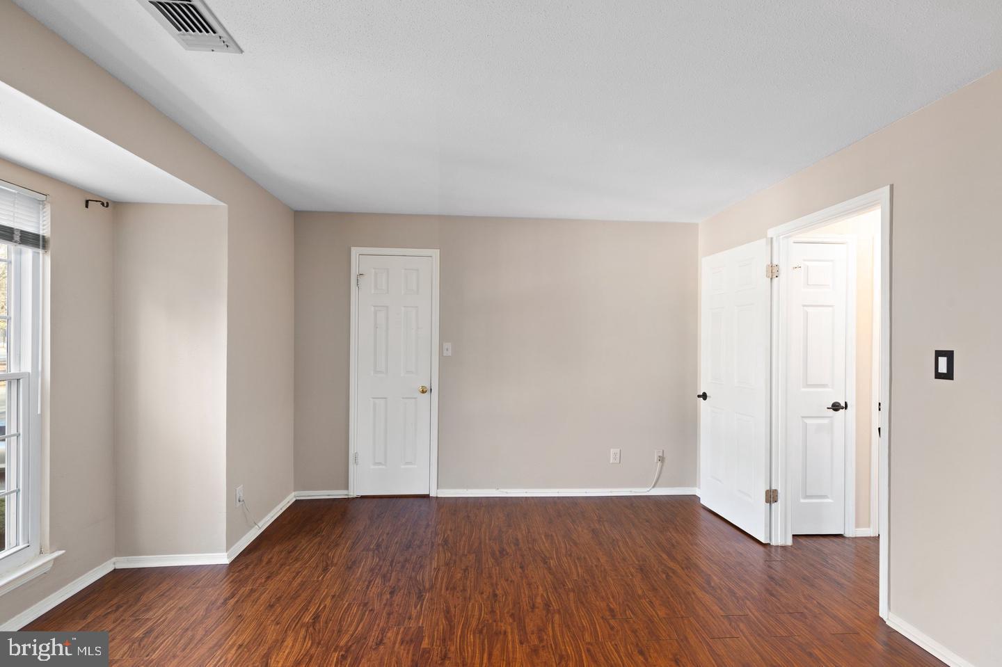 308 G Canterbury Road, Unit 308G Bel Air, MD 21014 - Photo 17 of 25 an empty room with wooden floor and windows
