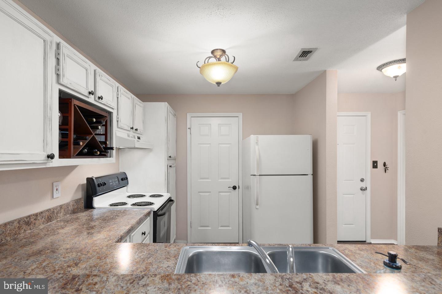 308 G Canterbury Road, Unit 308G Bel Air, MD 21014 - Photo 5 of 25 a kitchen with stainless steel appliances granite countertop a sink stove and refrigerator