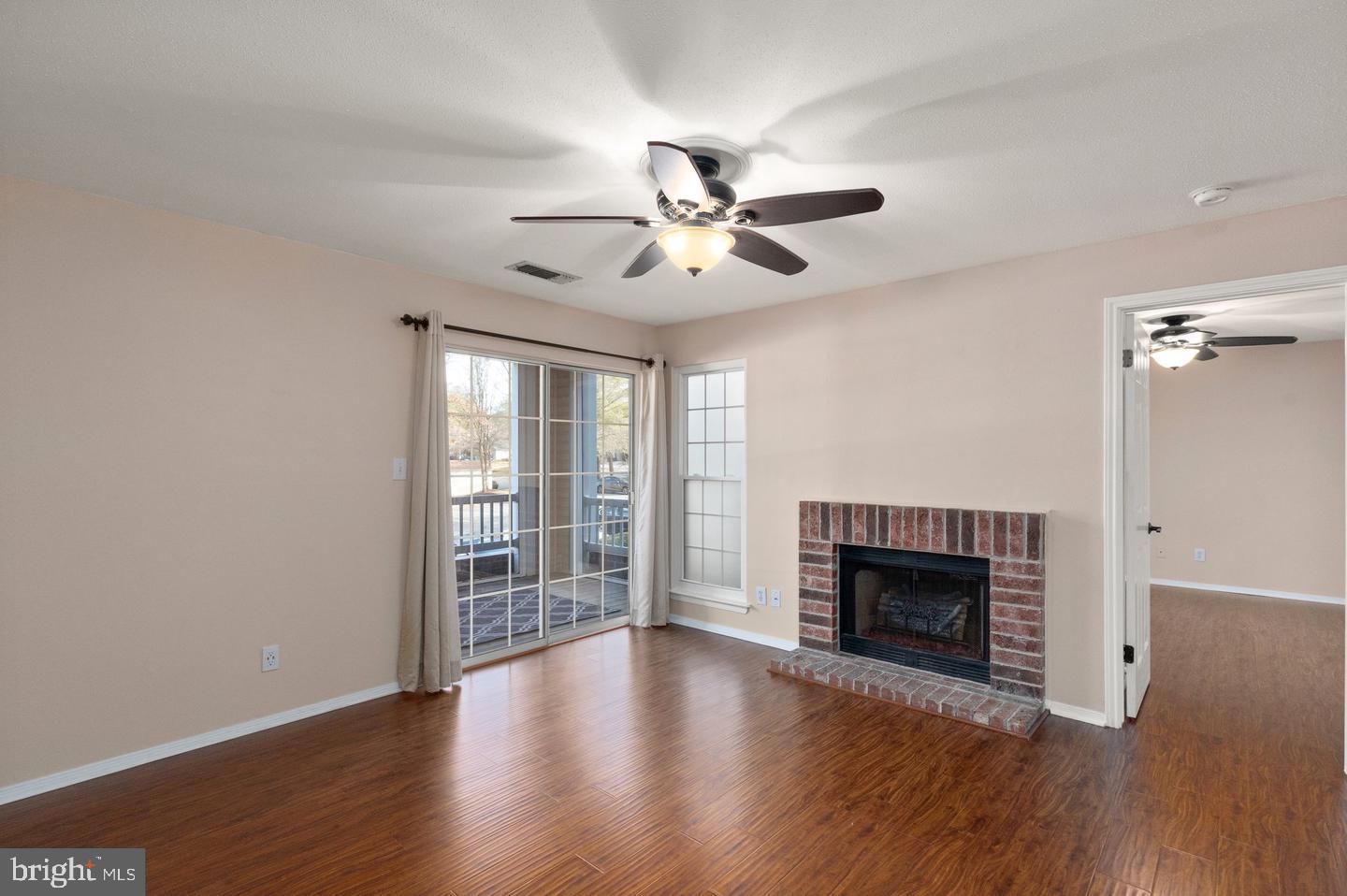 308 G Canterbury Road, Unit 308G Bel Air, MD 21014 - Photo 7 of 25 a view of a livingroom with a fireplace a ceiling fan and wooden floor