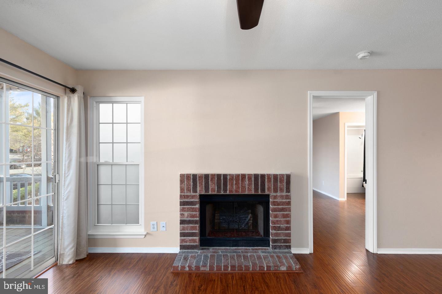 308 G Canterbury Road, Unit 308G Bel Air, MD 21014 - Photo 8 of 25 an empty room with wooden floor and fireplace