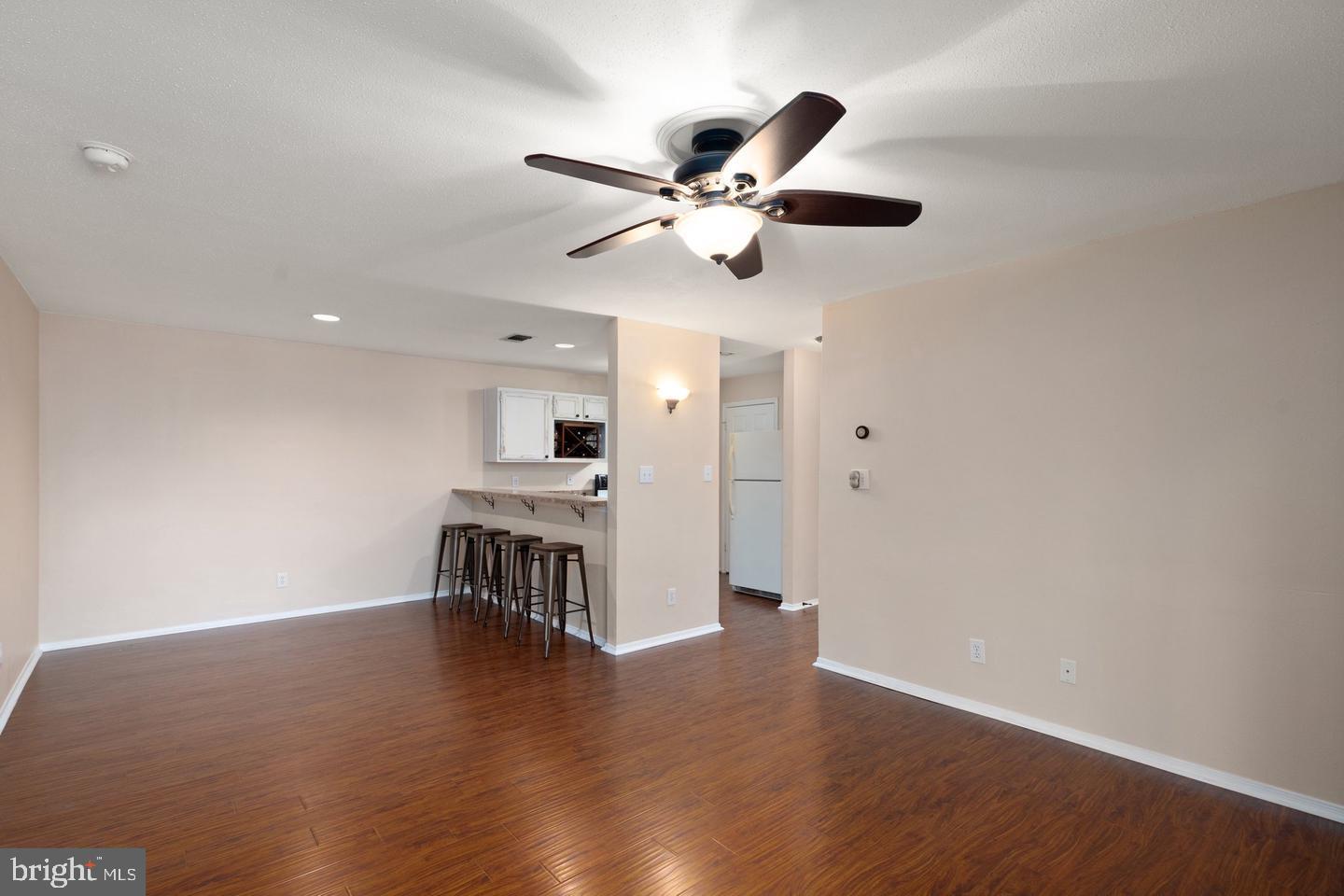 308 G Canterbury Road, Unit 308G Bel Air, MD 21014 - Photo 9 of 25 a view of a livingroom with a kitchen island wooden floor and a ceiling fan