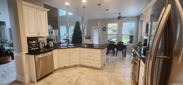 a kitchen with stainless steel appliances a refrigerator sink and cabinets