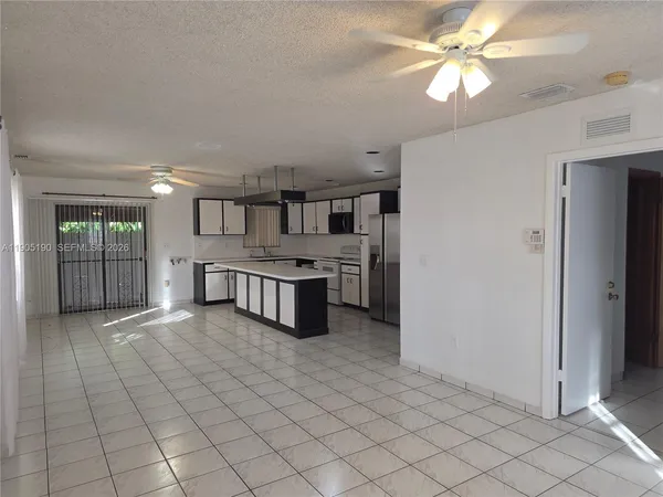 a view of a kitchen with microwave and cabinets
