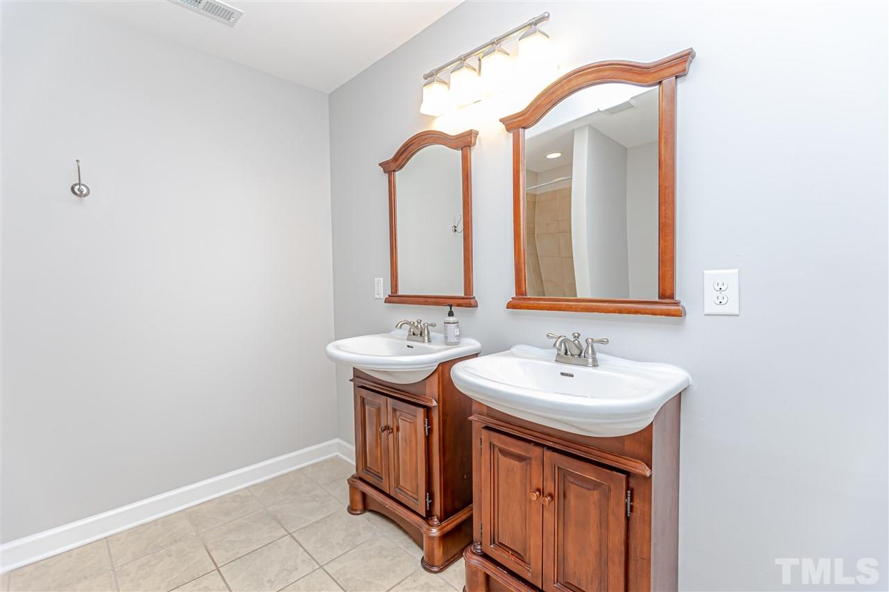 706 Hamilton Road Raleigh, NC 27604 - Photo 22 of 30 a bathroom with a sink and a mirror
