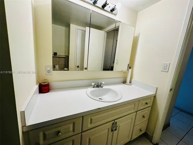 a bathroom with a toilet sink and a mirror