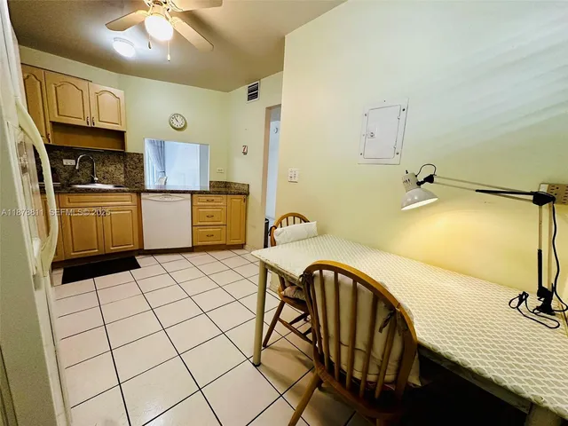 a view of a kitchen with a sink dishwasher and a refrigerator