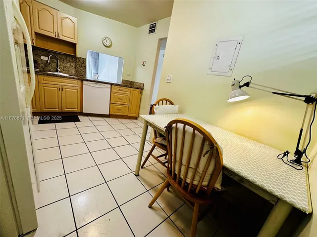 a kitchen with stainless steel appliances granite countertop a sink and cabinets