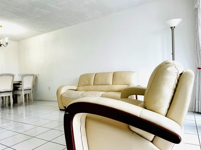 a living room with furniture and a chair