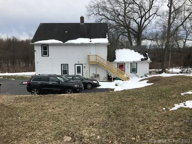 a view of a house with a yard patio and fire pit