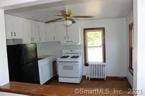 a kitchen with a stove a refrigerator and a window