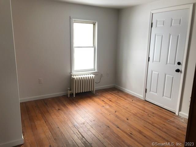 355 Lebanon Avenue Colchester, CT 06415 - Photo 4 of 6 an empty room with wooden floor and windows
