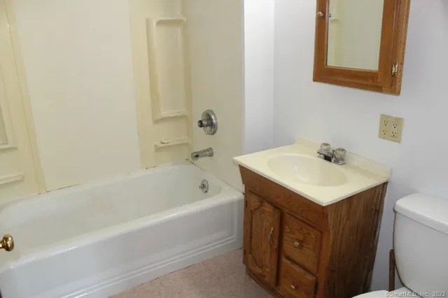 a bathroom with a sink a toilet and bathtub