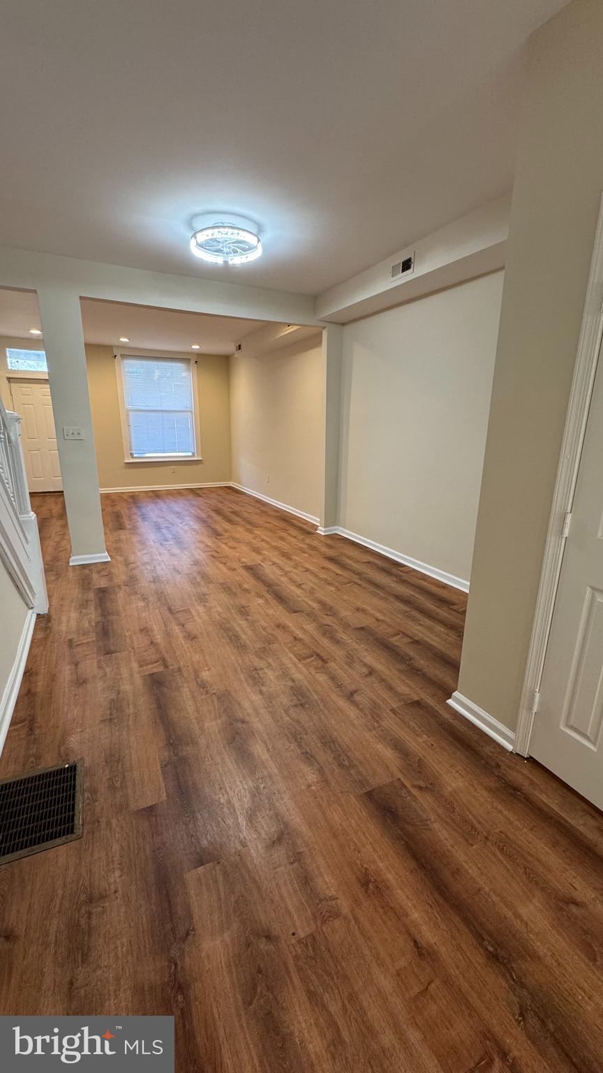 2786 The Alameda Baltimore, MD 21218 - Photo 4 of 17 wooden floor in an empty room with a window