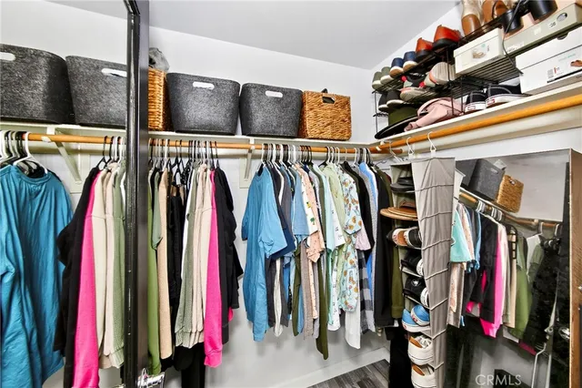 a view of walk in closet with clothes