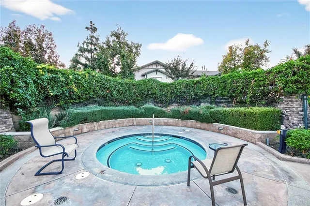 a view of a swimming pool with chairs in patio
