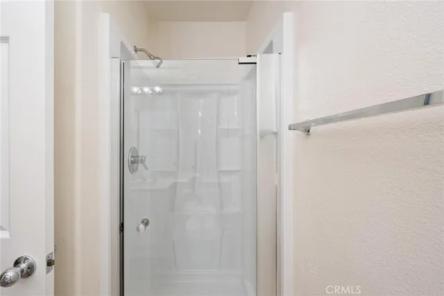 a bathroom with a glass shower door