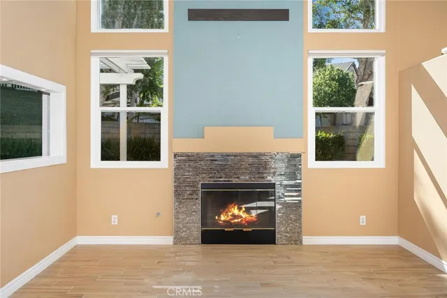 a view of an empty room with a window and fire place