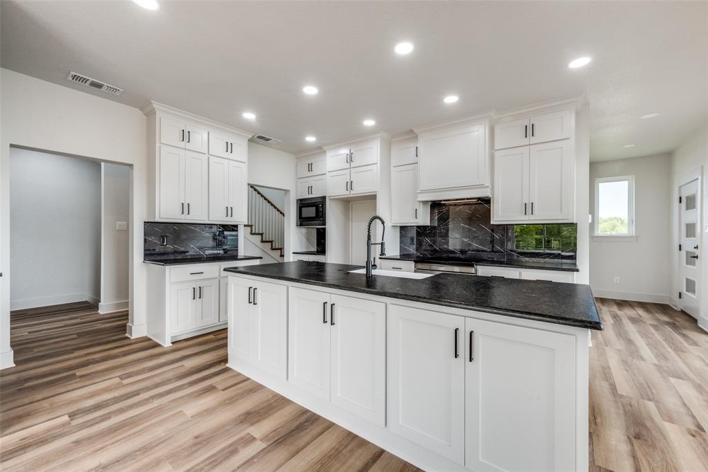 614 Twin Hills Road Lake Bridgeport, TX 76426 - Photo 12 of 25 a large kitchen with stainless steel appliances granite countertop a stove a sink and white cabinets