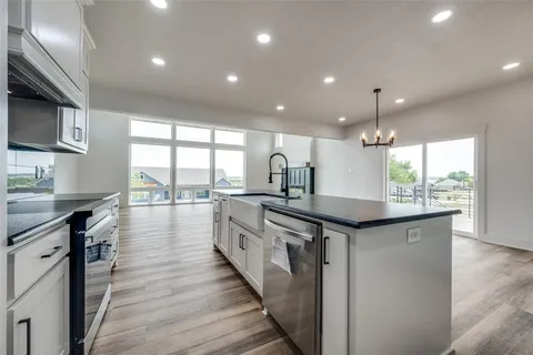 a view of empty room with wooden floor and window