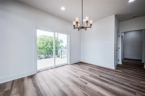a kitchen with granite countertop white cabinets and a window